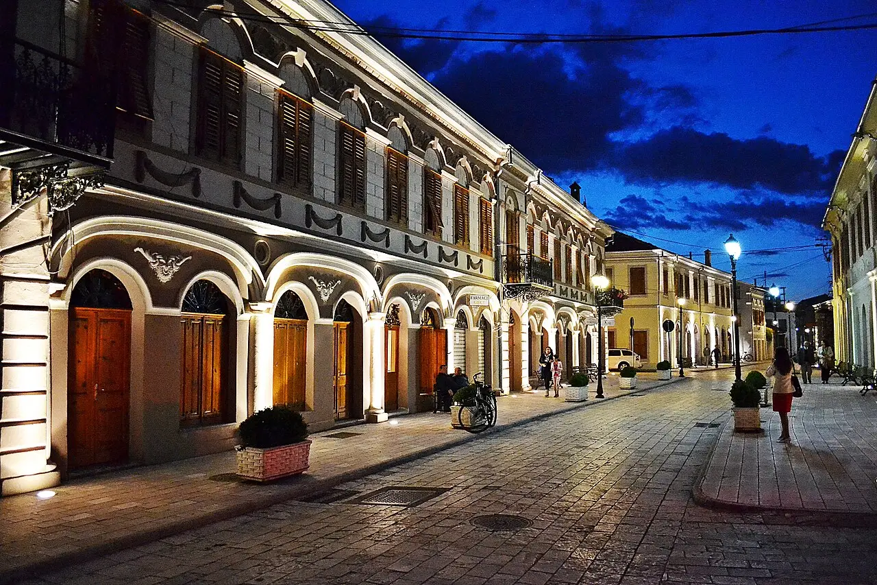 The arcaded old-town street of Rruga e Gjuhadolit in Shkodra lit up at dusk