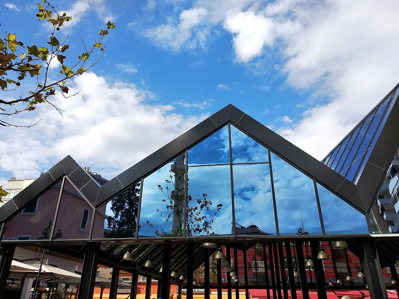 The restored New Bazaar (Pazari i Ri) in Tirana with market buildings, cafe tables and people