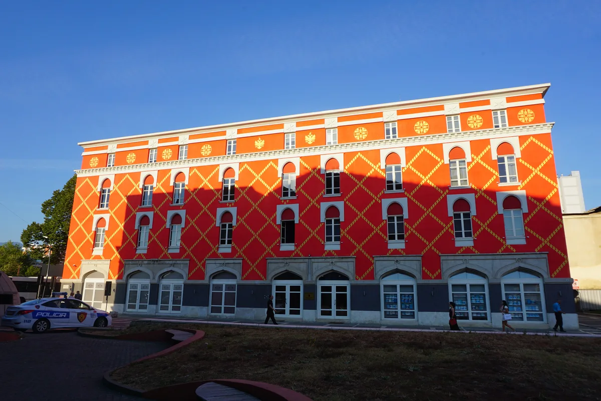 The red-patterned facade of the Ministry of Urban Development building in central Tirana