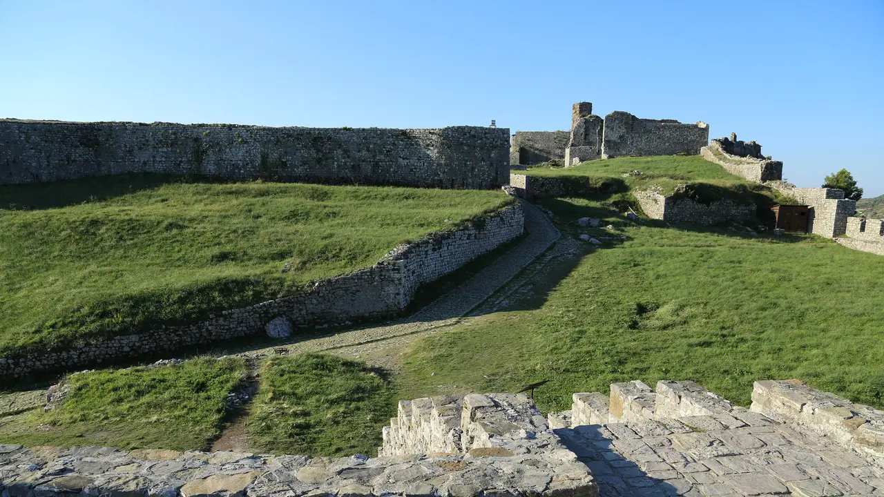 Evening light on the grassy inner ward and Venetian walls of Rozafa Castle above Shkodra