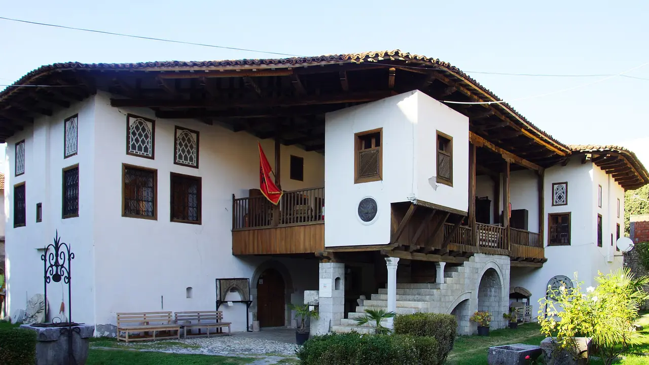 The white walls, wooden veranda and tiled roof of the Oso Kuka house, home of the Historical Museum of Shkodra